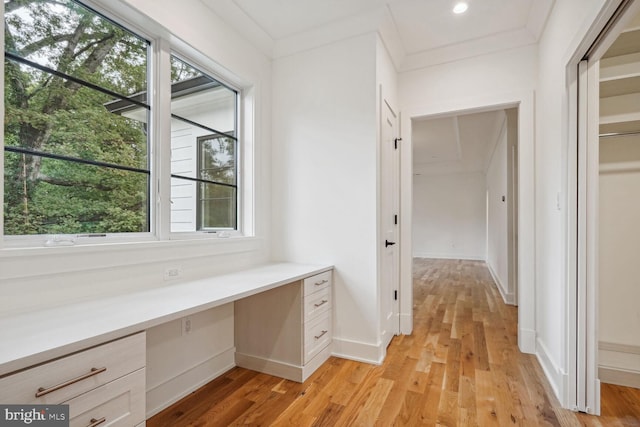 interior space with wood-type flooring and ornamental molding