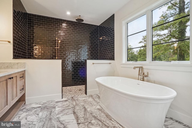 bathroom featuring vanity and independent shower and bath