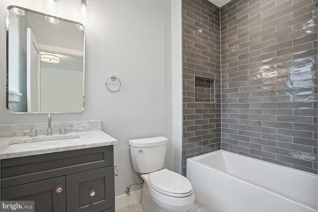 full bathroom featuring toilet, vanity, and tiled shower / bath