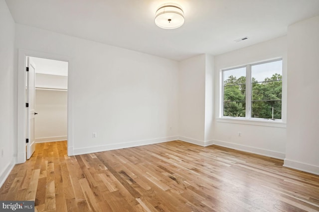 spare room with light hardwood / wood-style flooring