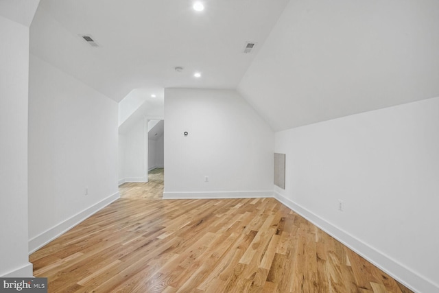 bonus room featuring light hardwood / wood-style floors and vaulted ceiling