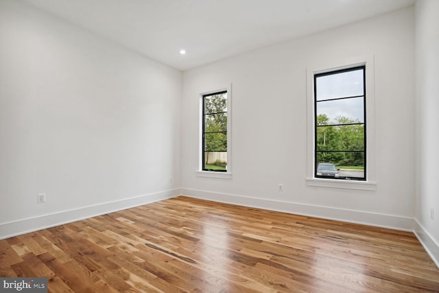 spare room featuring light hardwood / wood-style flooring