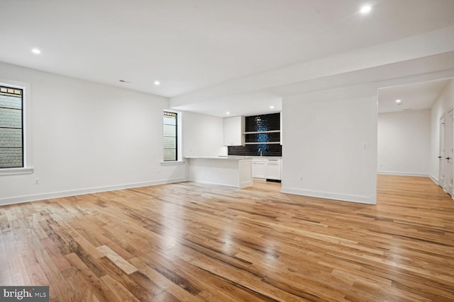 unfurnished living room with light hardwood / wood-style flooring