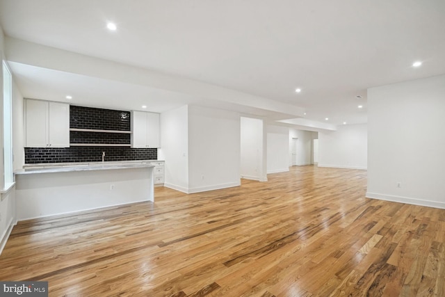 unfurnished living room with light hardwood / wood-style floors