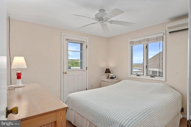 bedroom featuring an AC wall unit and ceiling fan