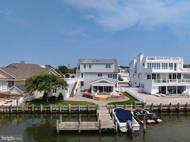 rear view of property with a water view