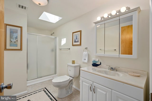 bathroom featuring vanity, toilet, walk in shower, and a skylight