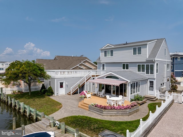 back of house featuring a patio area and a water view