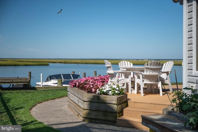 deck with a boat dock and a water view