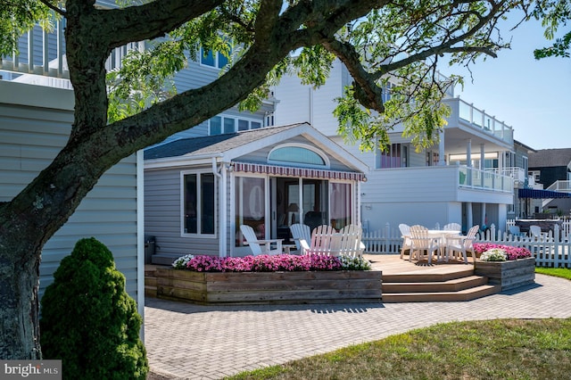 back of house with a balcony