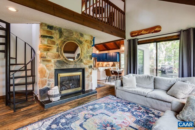 living room featuring a fireplace, hardwood / wood-style flooring, and lofted ceiling