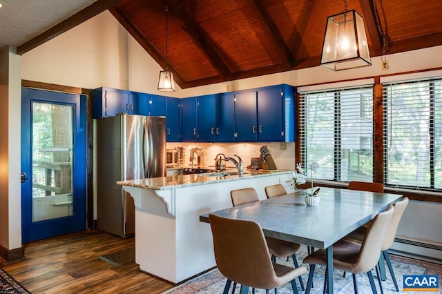 kitchen featuring light stone counters, wood ceiling, blue cabinets, pendant lighting, and stainless steel fridge