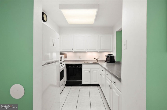 kitchen with sink, dishwasher, light tile patterned floors, and white cabinets