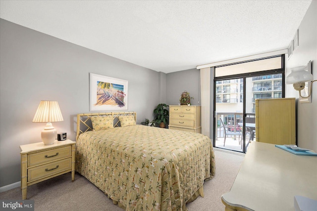 carpeted bedroom with floor to ceiling windows, access to exterior, and a textured ceiling