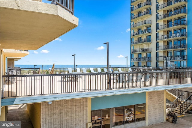 exterior space featuring a water view and a balcony