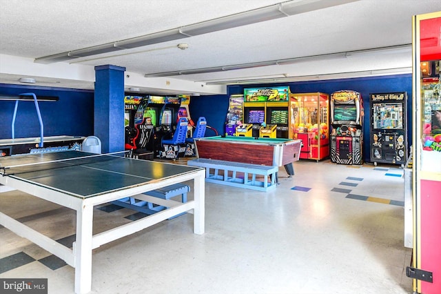 game room featuring a textured ceiling