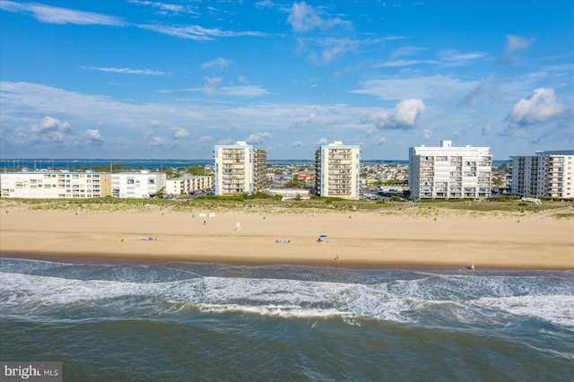 birds eye view of property featuring a water view and a beach view