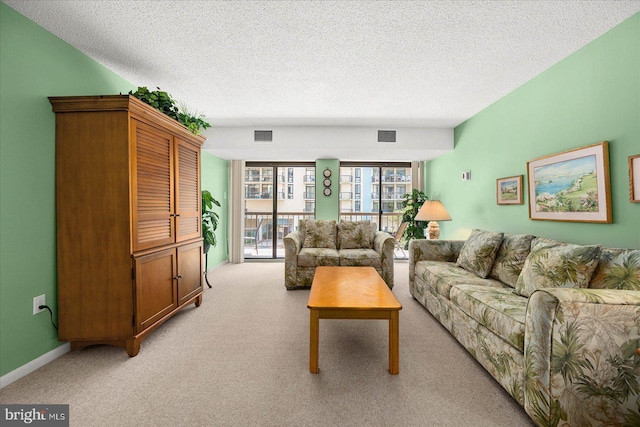 carpeted living room with a textured ceiling