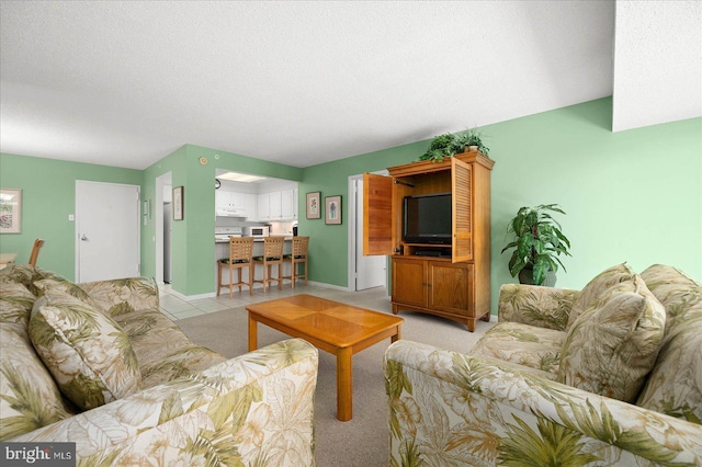 living room featuring light tile patterned floors and a textured ceiling