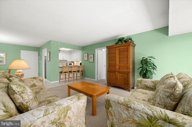 tiled living room featuring a textured ceiling