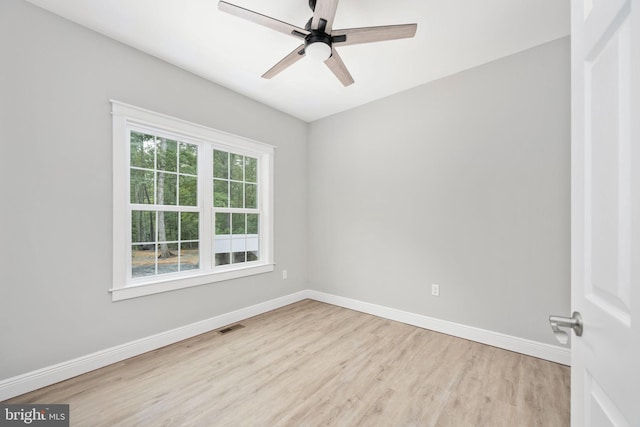 spare room with ceiling fan and light wood-type flooring