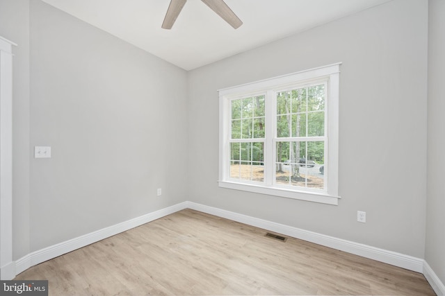 spare room featuring light wood-type flooring and ceiling fan