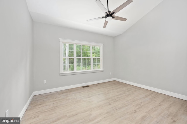 empty room featuring light wood-type flooring, lofted ceiling, and ceiling fan