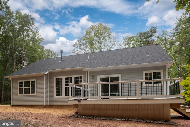 rear view of property featuring a deck