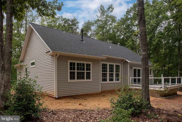 rear view of house with a wooden deck