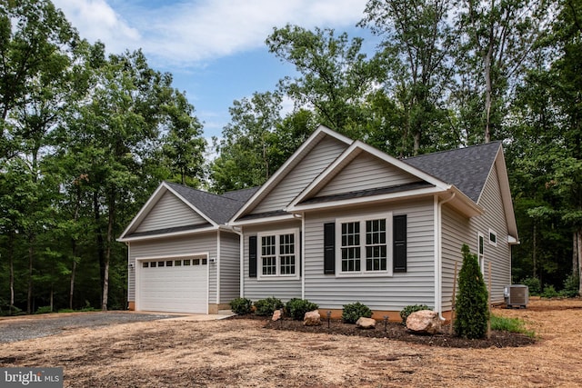 view of front facade featuring a garage and central AC