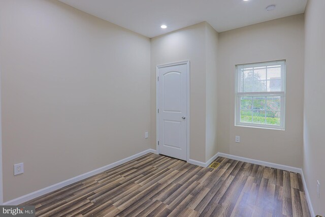 unfurnished room featuring dark hardwood / wood-style flooring