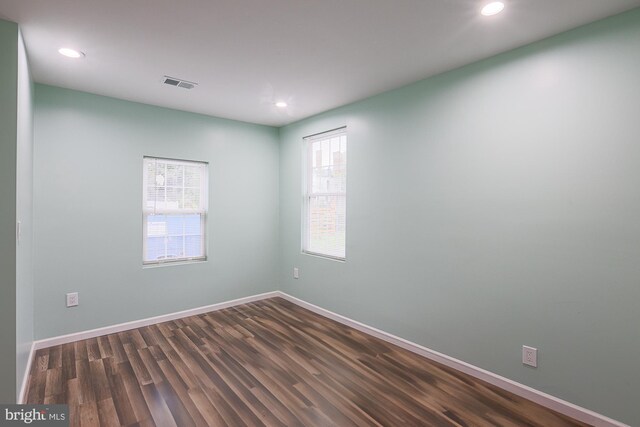 spare room with dark wood-type flooring