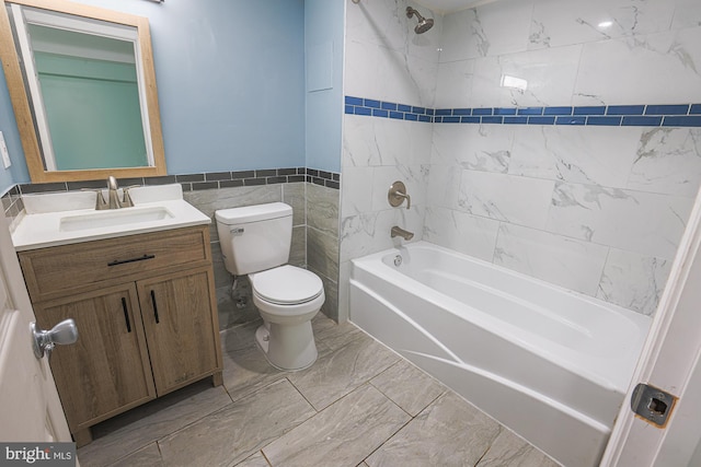 full bathroom with toilet, tile patterned floors, tiled shower / bath combo, tile walls, and vanity