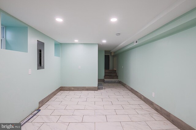 spare room featuring light tile patterned flooring and electric panel