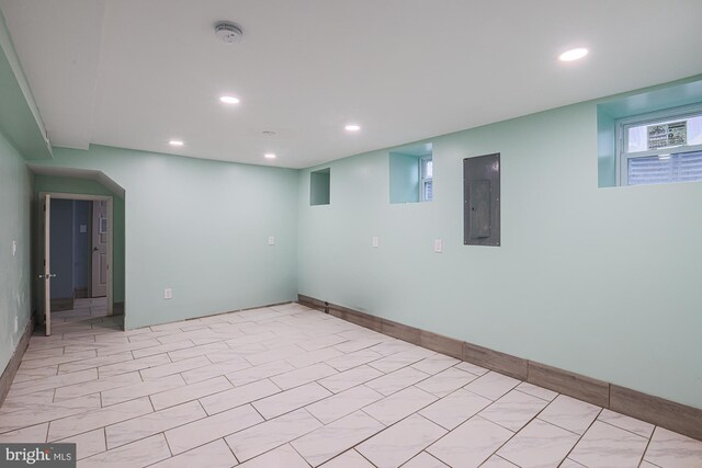 empty room with electric panel and light tile patterned floors