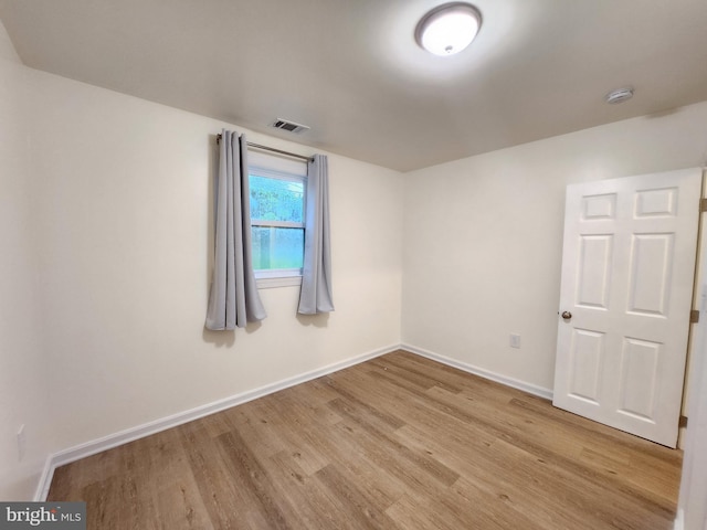 empty room with light hardwood / wood-style flooring