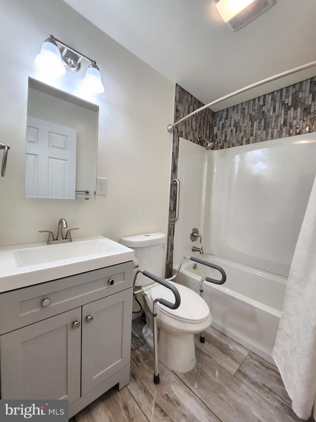 full bathroom featuring vanity, hardwood / wood-style flooring, toilet, and shower / bath combination with curtain