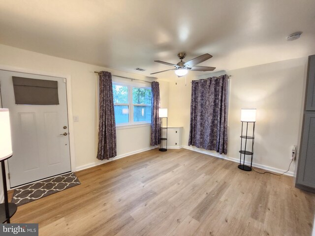 foyer entrance with light wood-type flooring and ceiling fan