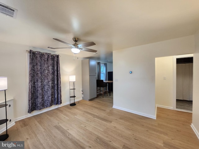 unfurnished living room featuring ceiling fan and light hardwood / wood-style flooring