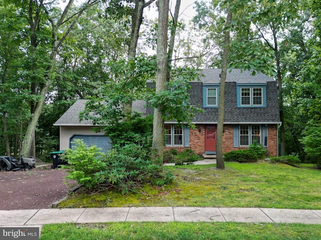 view of front of house featuring a garage and a front lawn