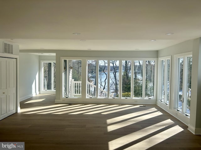 unfurnished sunroom featuring visible vents