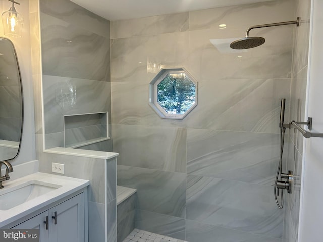 bathroom with walk in shower and vanity