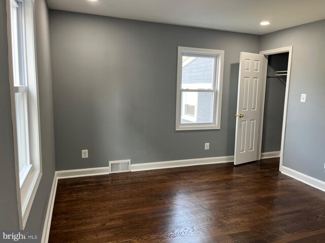 empty room featuring dark hardwood / wood-style flooring