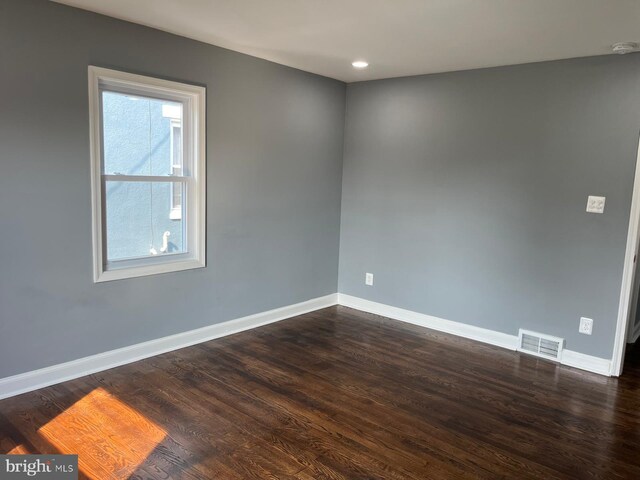 unfurnished bedroom with hardwood / wood-style flooring and a closet