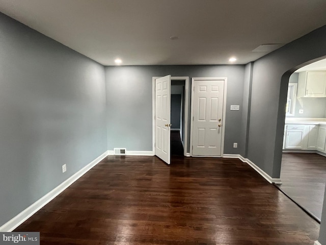 unfurnished bedroom with dark wood-type flooring