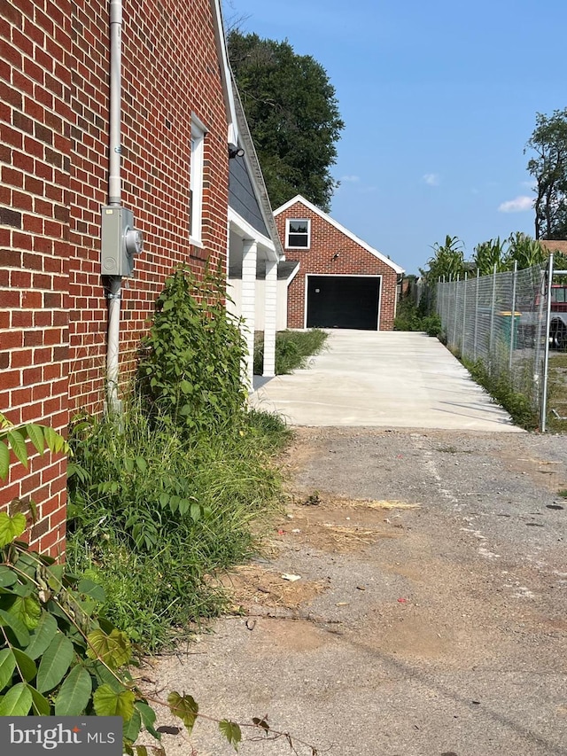 view of home's exterior featuring a garage and an outdoor structure