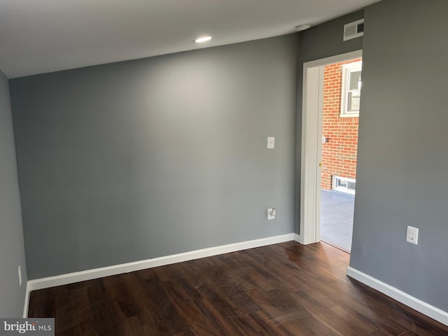 spare room featuring hardwood / wood-style flooring and vaulted ceiling