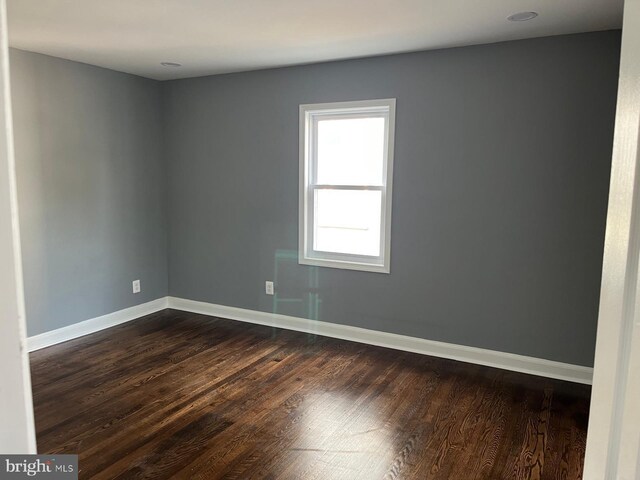 unfurnished room with wood-type flooring