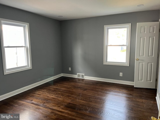 spare room with dark hardwood / wood-style flooring