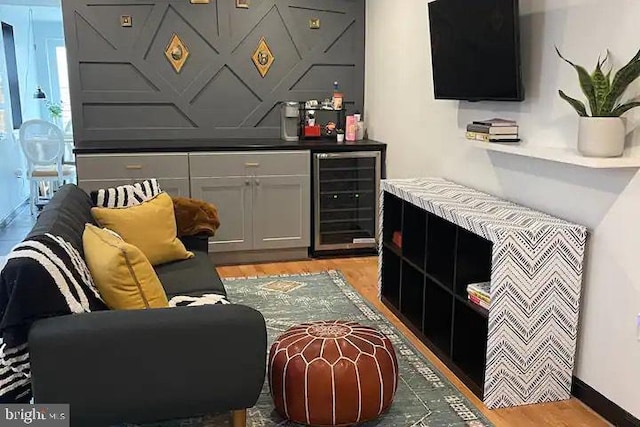 interior space featuring light hardwood / wood-style flooring, white cabinets, and wine cooler